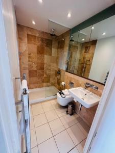 a bathroom with a sink and a tub and a toilet at Luxury Studio Apartment The Cube Birmingham City Centre in Birmingham