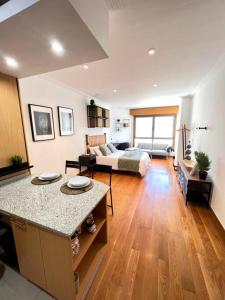 a large living room with a couch and a table at Central Suites Poli Sanz in Vigo