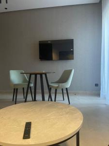 a room with two chairs and a table and a tv at Magic Appartement Luxury Gauthier 04 in Casablanca