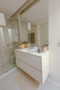 a white bathroom with a sink and a mirror at Casas do Forte Wood 6pax Piscina Privativa by Portugal Hideaway in Tavira