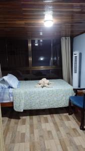 a bedroom with a bed with a stuffed animal on it at Natural Pacific Suites in Manuel Antonio