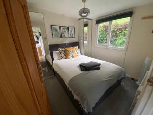 a bedroom with a bed with pillows and a window at 27 Sea Valley Chalet in Bucks Mills