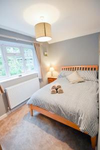 a bedroom with a bed with two donuts on it at Charming Malvern Cottage with Outstanding Views in Malvern Wells