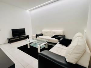 a living room with a couch and a table at Appartement - Rue du Canal in Esch-sur-Alzette
