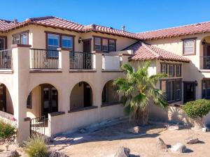 a large house with a palm tree in front of it at El Dorado Ranch San Felipe Beach Condo 73-3 in La Ponderosa +32 photos