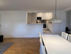 斯德哥爾摩的住宿－Apartment with amazing view，用餐室以及带白色桌椅的厨房