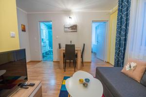 a living room with a couch and a table at Calendula apartments in Tuzla +47 photos