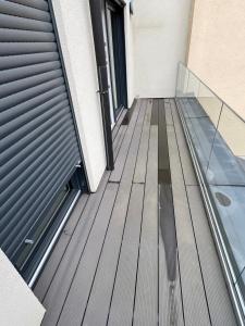 a wooden deck on a building with a door at Appartement - Rue du Canal in Esch-sur-Alzette