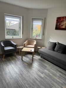 a living room with a couch and a chair at Gartenparadies mit Rheinblick in Urbar in Urbar-Mayen-Koblenz