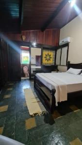 a bedroom with a large bed in a room at Barbanera Club & Hotel de Charme in Caucaia