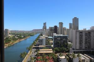 a river in the middle of a city with tall buildings at Hawaiian Monarch 2010 condo in Honolulu