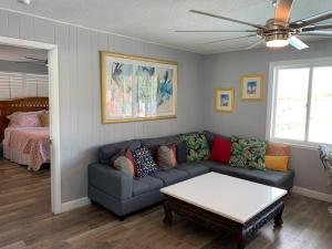 a living room with a couch and a table at Oceanview home on Indian Rocks Beach in Clearwater Beach