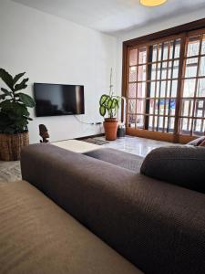 a living room with a couch and a flat screen tv at Casa compartida San Francisco in Santa Cruz de Tenerife
