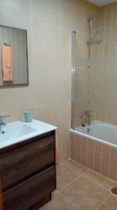 a bathroom with a tub and a sink and a shower at Casa Chocolate San Miguel del Pino Valladolid in San Miguel del Pino