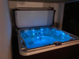 a bath tub with a blue water in it at Location Eyheraldia votre Triplex au cœur du Pays Basque in Hasparren