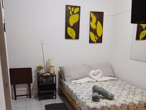 a bedroom with a bed and two pictures on the wall at Yellow-Gray Tropical Studio in San Juan