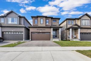 a large house with a garage at Modern 1 Bedroom + Den in Cambridge in Cambridge