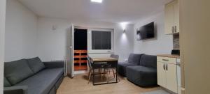 uma sala de estar com um sofá e uma mesa em Kope, Jagoda 8 - Studio 2 em Slovenj Gradec