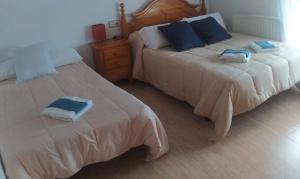 A bed or beds in a room at La Morada del Tejar