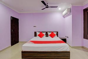 a bedroom with a bed and a ceiling fan at Flagship VENTURE INN GUEST HOUSE in Bhubaneshwar