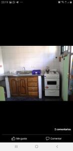 a kitchen with a white stove and a sink at Ruca Leiva in San Carlos de Bariloche