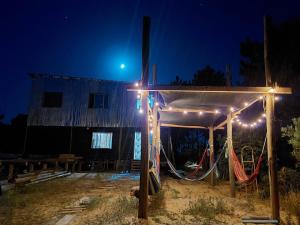a playground under a tent at night with lights at Casa Copada in Punta Del Diablo