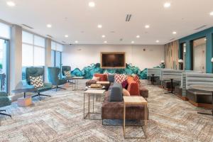 a lobby with couches and chairs and a television at Downtown Luxury Oasis: King Bed, Gym, Parking in Chelsea