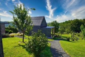 une maison avec un chemin en gravier devant elle dans l'établissement Hišice Čarna - Houses Čarna, à Puconci