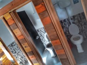 an overhead view of a bathroom with a toilet at Casa Copada in Punta Del Diablo +26 photos