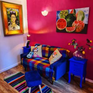 a living room with a couch and a pink wall at Frida's Cottage Whitby in Whitby +39 photos