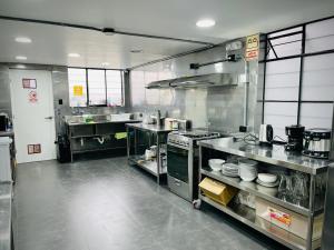 a large kitchen with stainless steel appliances in a kitchen at Idea Home in Lima