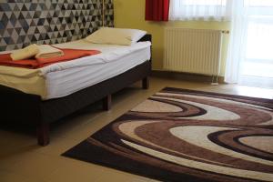 Postel nebo postele na pokoji v ubytování Auguszta Hotel