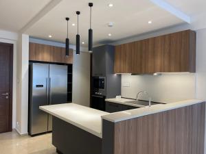 a kitchen with a counter top and a refrigerator at Solaris Appartment 5&7th floor in Accra