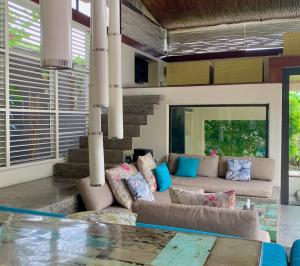 a living room with a couch and a table at Kiss Bali Villas in Seminyak