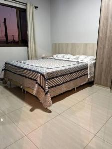 a bed is sitting in a room with at Acomodação Três Fronteiras Foz in Foz do Iguaçu +49 photos