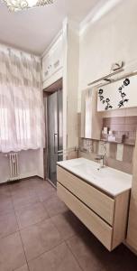 uma grande casa de banho com um lavatório e um chuveiro em Appartamento nel cuore di Aosta em Aosta