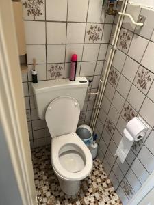 a bathroom with a white toilet in a room at Nice house in Rotterdam