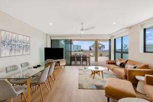 a living room with a couch and a table at Pure Kirra in Gold Coast