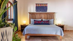 a bedroom with a bed with a wooden headboard at QUINTA BERNAL in Lo de Marcos