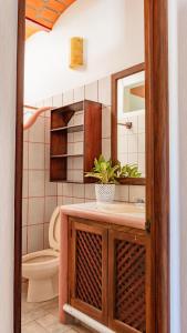 a bathroom with a sink and a toilet and a mirror at QUINTA BERNAL in Lo de Marcos