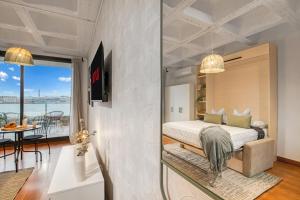a bedroom with a bed and a view of the ocean at Cozy Penthouse, 20 min to downtown, Alcalá Norte in Madrid