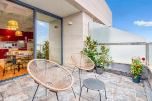 a patio with two chairs and a table at Cozy Penthouse, 20 min to downtown, Alcalá Norte in Madrid