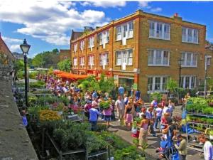 a crowd of people standing around a garden at Shut Eyes in London