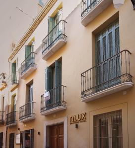 a building with balconies on the side of it at Alux Boutique Hotel in Málaga