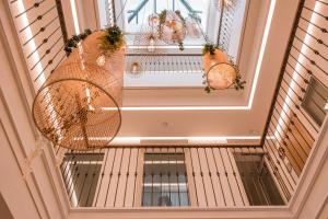 an image of a hallway with a spiral staircase with at Alux Boutique Hotel in Málaga