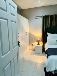 a bedroom with a bed and a door with a view at Coastal Bliss at Ongwe in Swakopmund