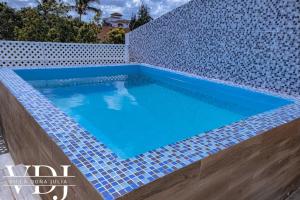 a swimming pool with blue tiles on a wall at Rooftop with Pool, La Romana, Villa Doña Julia in La Romana