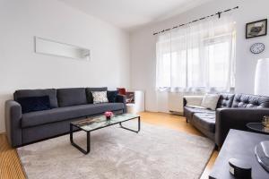 a living room with a couch and a table at Apartment Ana By Blue Apartments in Zagreb