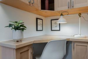 a kitchen with a desk with a potted plant on it at Casa Creekside - Walk to Gondola, Shops, lakes! in Whistler