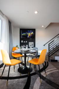 a dining room with a table and chairs and a tv at Spacious Luxury Villas in the heart of LA! Free parking and Jacuzzi in Los Angeles
